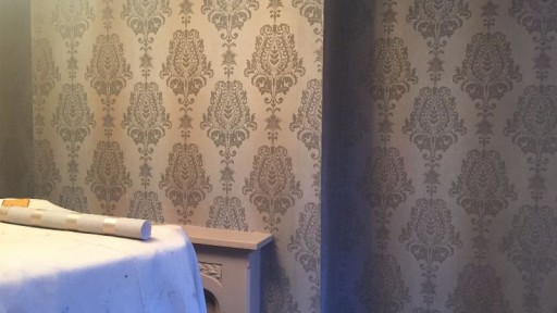 Living room walls after applying wallpaper.