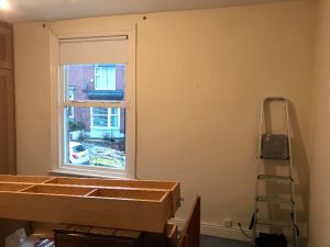 Preparing the walls for painting.