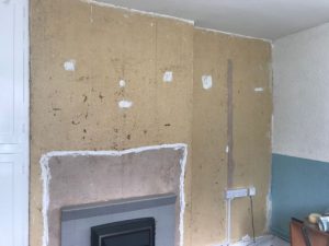 Before wallpapering the wall.