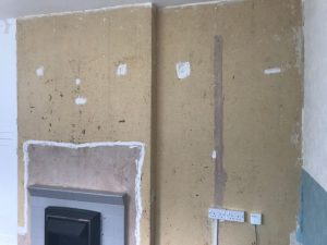 Before wallpapering the wall.